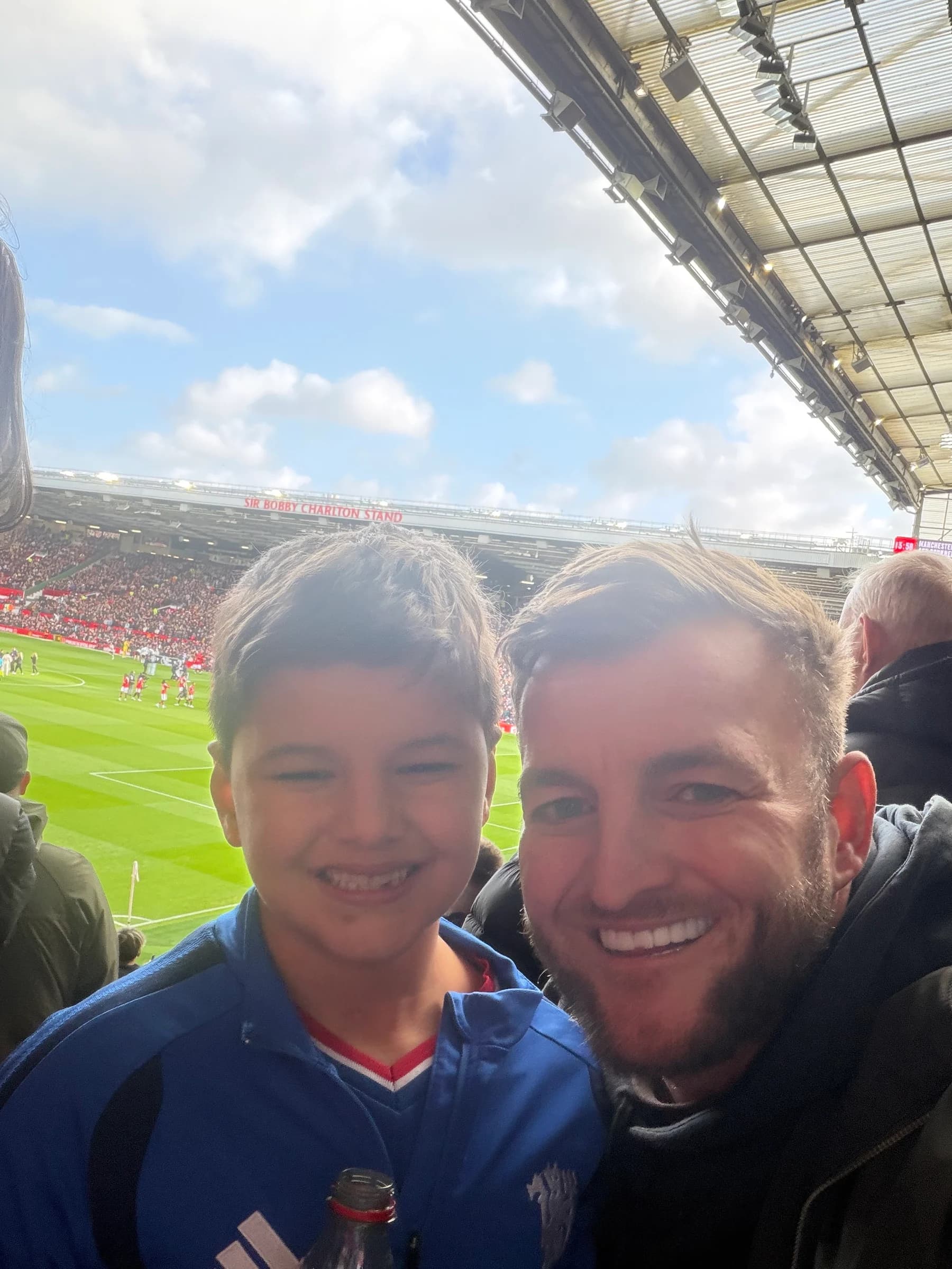 David Walsh and his son Leo smiling together at a football match